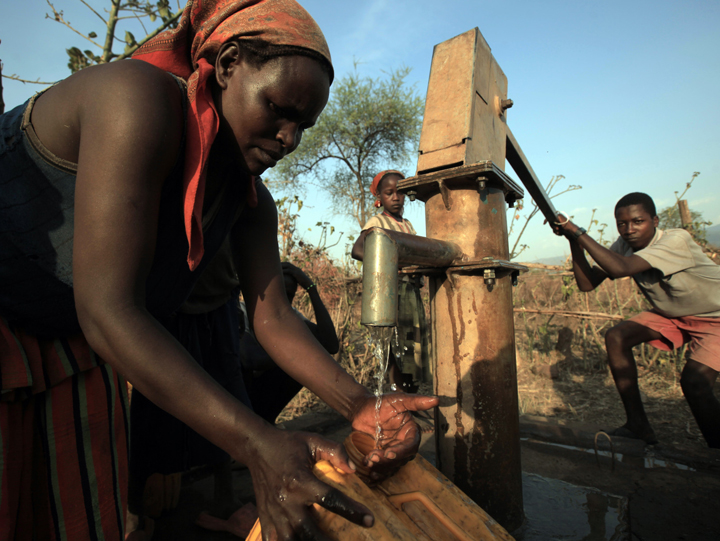 Woman Collecting Water from a Borehole
